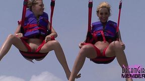 Wild exhibitionists flashing their tits and bare pussies while parasailing on a public beach - HD - 10:30 video - from XGroovy