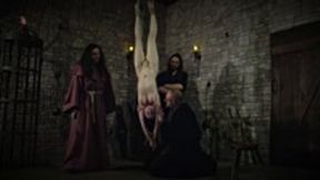 Mooin Witch – The exhausted milkmaid is pulled upside down to the ceiling with weights at her wrists to be tormented and interrogated further and to see milk flowing - SD - 19:16 video - from Clips4sale